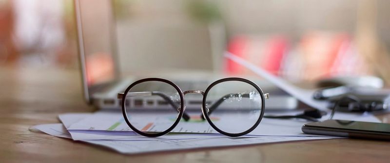 Close-up of Eyeglasses on Desk_Issarapong Suya_GettyImages-728872683